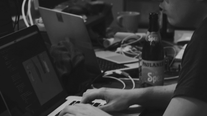 a video showcasing a man working on a laptop, a printer at work, a laser and more fast cuts